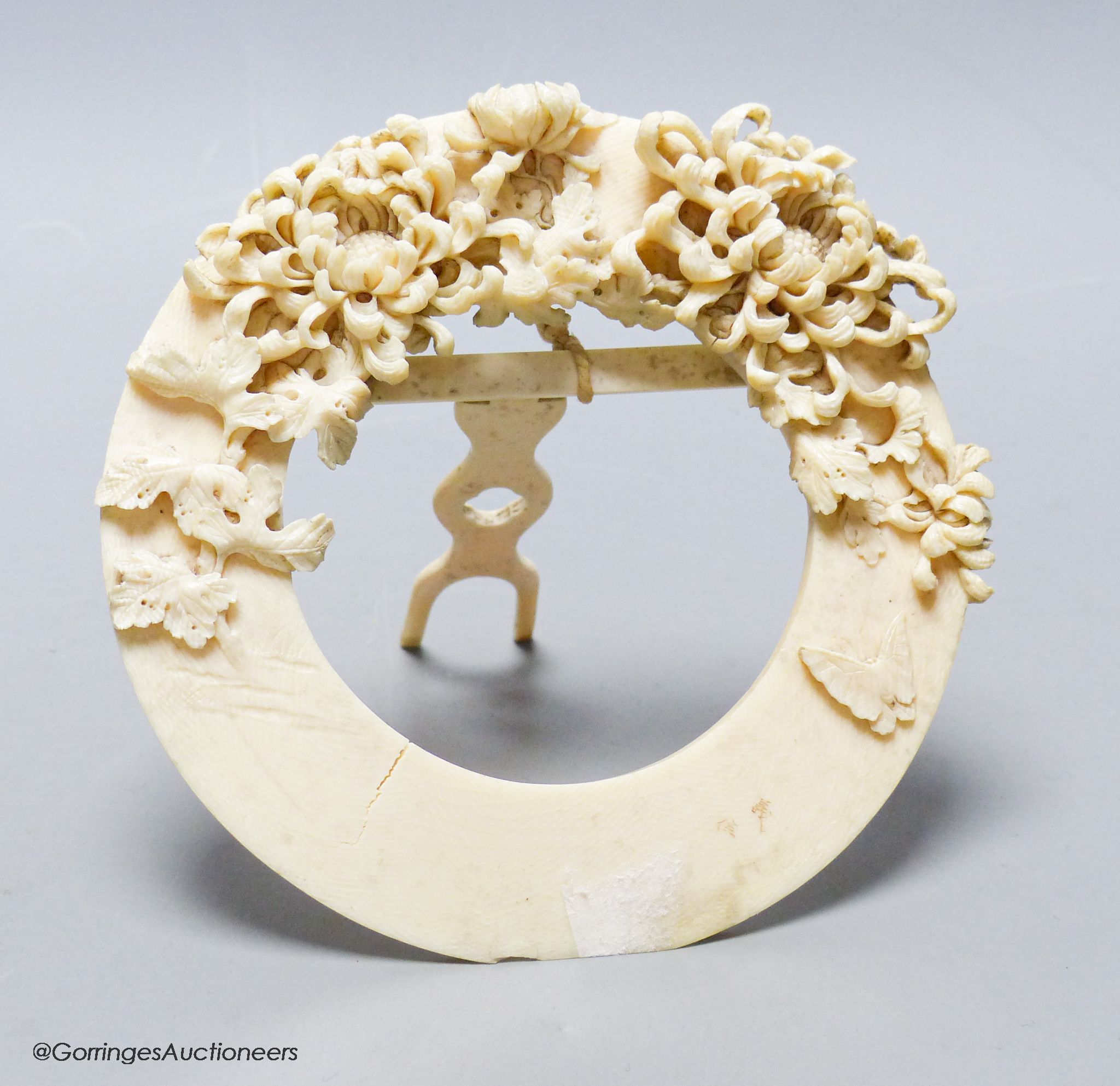 A circular carved ivory picture frame